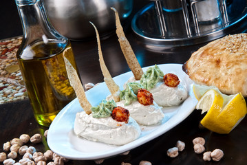 Healthy Homemade Creamy Hummus with Olive Oil and Pita Chips.