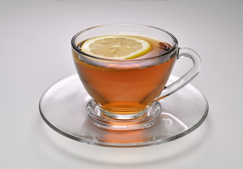 Cup of tea with lemon on white background