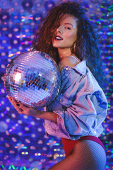 Young beautiful girl with long curly hair in ultraviolet light.