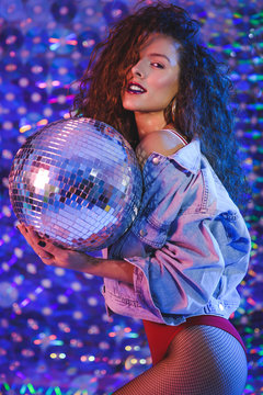 Young beautiful girl with long curly hair in ultraviolet light.