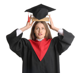 Female graduating student with books on white background