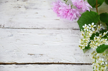 spring white and lilac or purple flowers on wooden background