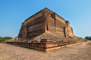 monumental uncompleted stupa Pahtodawgyi Paya destroyed by earthquake in Mingun Mandalay, Myanmar (Burma) on Western bank of Irrawaddy river on the background of blue sky