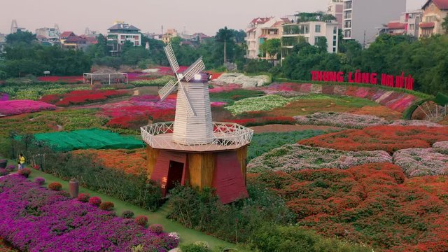 HANOI, VIETNAM - APRIL, 2020: Aerial panorama view of the flower garden with decorative mill in Hanoi.