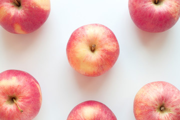 Fresh red apples close-up on a white background. Fruit composition, pattern, vitamin food poster. Top view, flat lay.