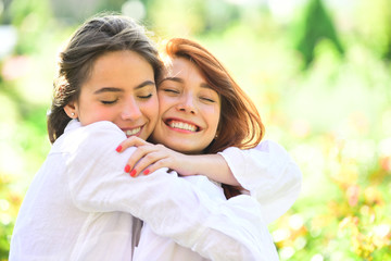 Obraz premium Beautiful girls in park. Two Beautiful redhead girl. Cheerful sister friend, embrace concept.