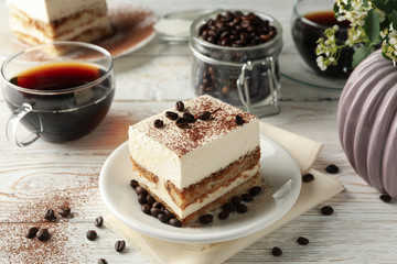 Composition with tasty tiramisu on white wooden background. Delicious dessert
