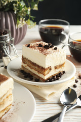 Composition with tasty tiramisu on white wooden background. Delicious dessert