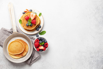 Delicious pancakes with berries and jam