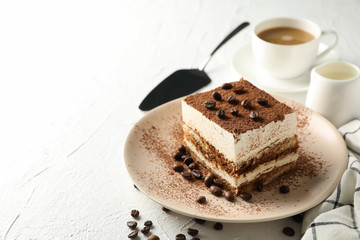 Composition with plate of tasty tiramisu on white background. Delicious dessert