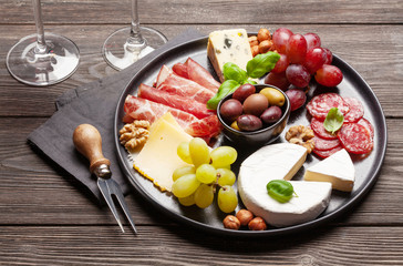 Cheese, meat, grapes and olives antipasto