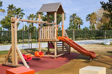 Playground with slide and swings in a children park