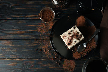 Composition with tasty tiramisu and coffee on wooden background