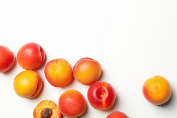 Fresh tasty apricots on white background, top view
