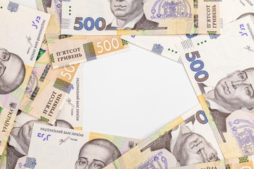 Ukrainian Financial money background. Hryvnia, new banknotes of 500 Hryvnia or UAH forming a frame with white in the middle.