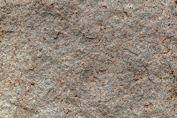 Granite texture, granite background, granite stone closeup on an unpolished real flat stone surface level.