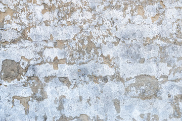 Abstract vintage grunge dirty wall background texture with wall covered up in fungus and stucko dents.