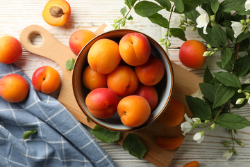 Composition with tasty apricots on white wooden background, top view