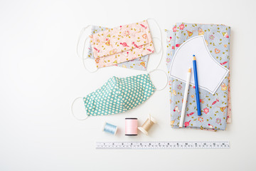 Homemade cotton face mask with accessories on white background
