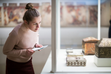 woman standing near exposition  in art museum - obrazy, fototapety, plakaty