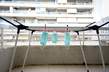 face masks drying on a clothes rack. New normal concept