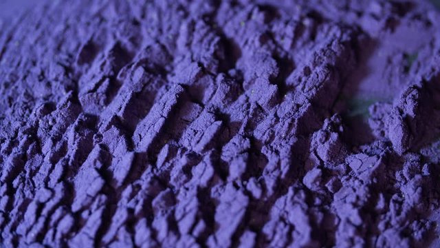 Macro shot of colored makeup powder. Concept. The appearance of cracks on the surface of the powder.