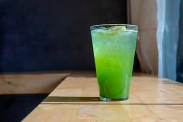 Italian Soda Cold Beverage and Kiwi Fruit on top in cafe.