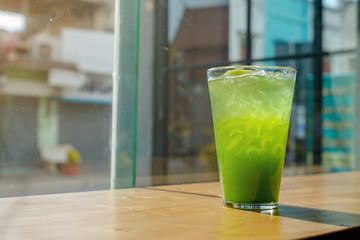 Italian Soda Cold Beverage and Kiwi Fruit on top in cafe.