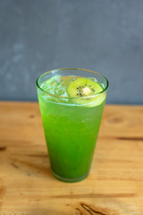 italian Soda Cold Beverage and Kiwi Fruit on top in cafe.