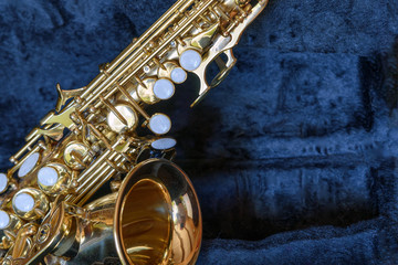 Piccolo saxophone fragment in an open case close up