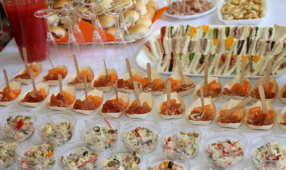 set table with many sandwiches and appetizers