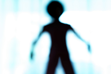 Blurred silhouette of human body look like alien. © marchsirawit