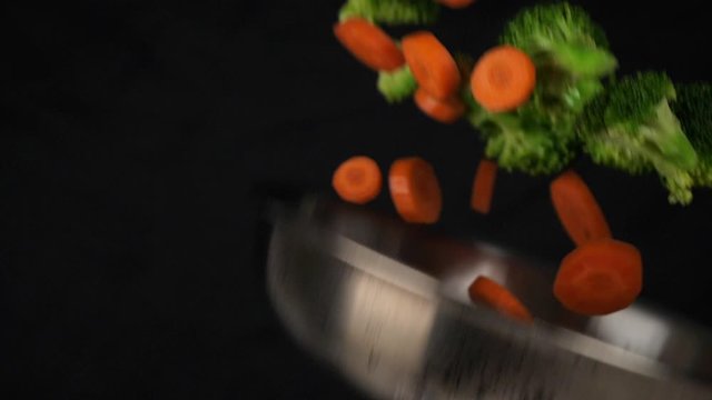 frying carrot and broccoli- slow motion