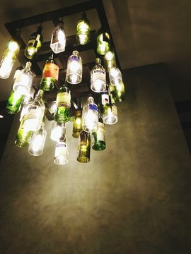 Low Angle View Of Illuminated Light Fixture Hanging From Ceiling