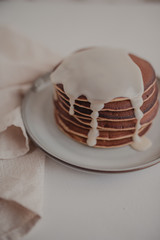 Appetizing pancakes with condensed milk on a gray plate. Background with a sweet breakfast.