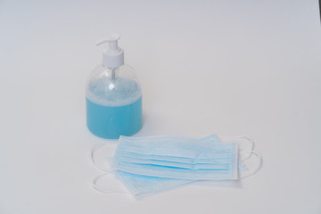 Surgical face mask and alcohol gel protect yourself from COVID-19. Medical concept