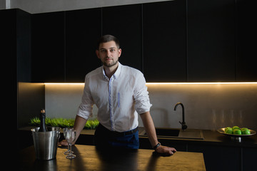 man in a white shirt custom sleeves in kitchen