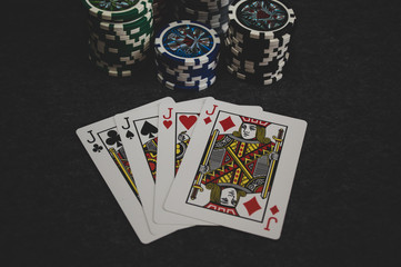 playing cards and poker chips on grey background