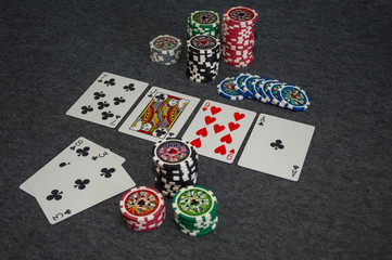 playing cards and poker chips on grey background