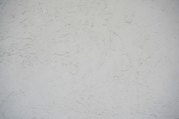 White concrete wall showing random textures of brush strokes.  Building construction, renovation design material.  Blank for copy space.