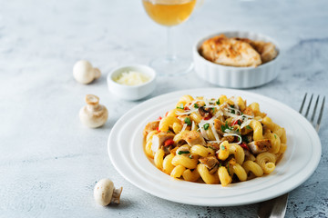Roasted chicken mushroom pepper pasta in a white plate