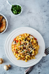 Roasted chicken mushroom pepper pasta in a white plate