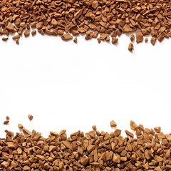 golden color freeze dried coffee, instant coffee granules on a white background close-up,...
