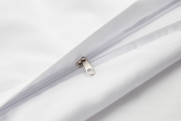 zipper on white cotton product, bed linen