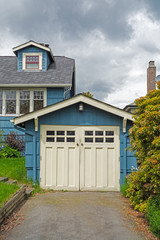 Detached single stall garage on front yard of residential house