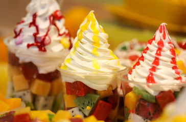 Ice cream with fruits and berries in a waffle glass.