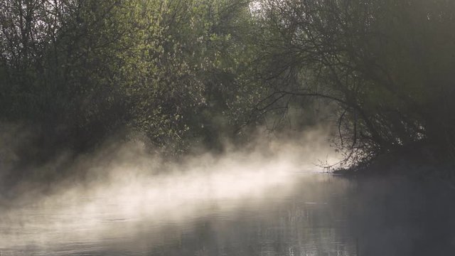 Morning fog on the river at sunrise. Misty landscape