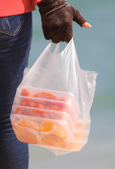 A man sells a pulp of fruit on a beach