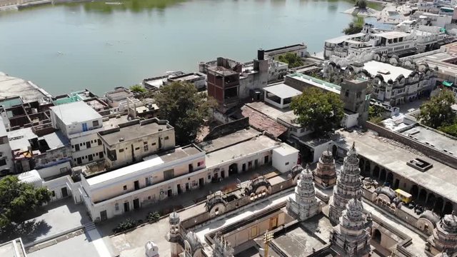 Aerial views of the beautiful sacred Pushkar Lake in Rajasthan, India. Flyover tilt up shot.
