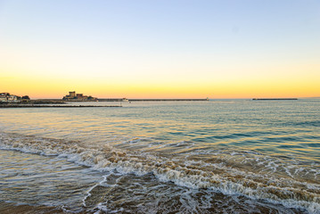 Naklejka premium Golden sunrise in Socoa, at the entrance to the port. Saint Jean de Luz, France